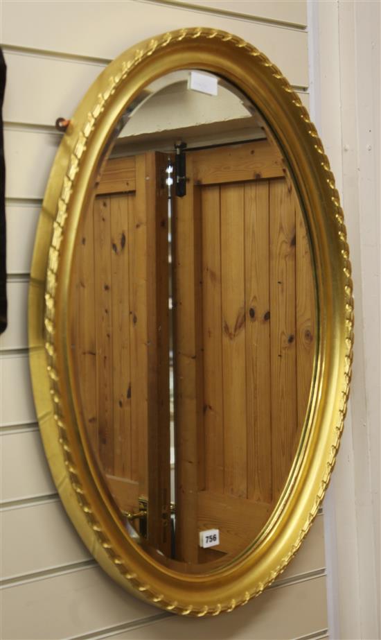 An oval gilt framed mirror W.60cm